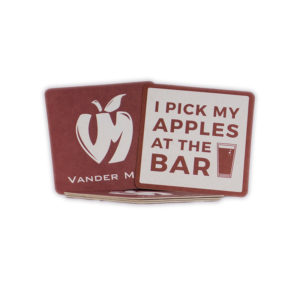 Vander Mill maroon fiber coasters with an off-white apple logo on the front and "I pick my apples at the bar" on the back